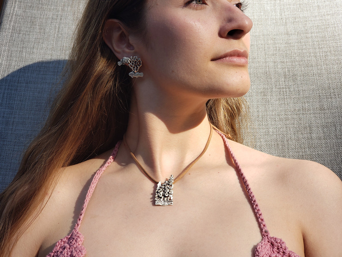 Modelo luce arete de plata con forma de coral con pez payaso. Aretes de plata 925 elaborados con materiales sustentables, simbolizan protección, sanación y adaptabilidad. Joyería artesanal mexicana.