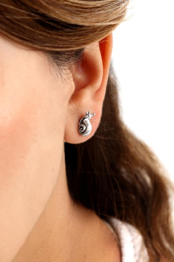 Modelo porta un arete de plata pequeño con forma de caracol